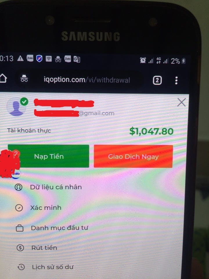 An IQ Option support message notification indicating an account suspension due to terms violations and fraud checks